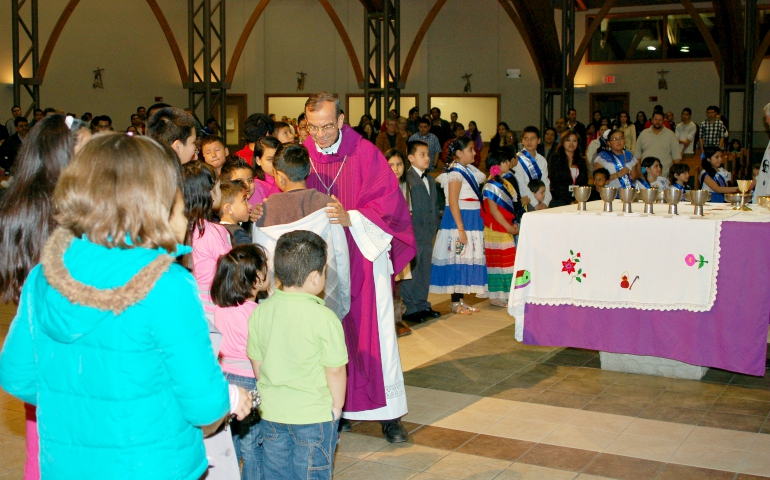 Auxiliary Bishop Gregorio Rosa Chávez of San Salvador greets Salvadoran youth at St. Sabina Parish in Belton, Missouri. (Courtesy of St. Sabina Parish)