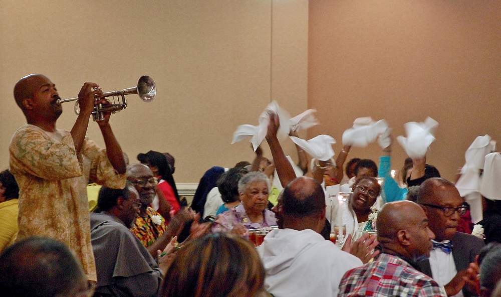 Deacon Melvin Tardy rouses the crowd the evening of July 29 with "When the Saints Go Marching In," at the joint meeting between the National Black Sisters Conference and three black clergy groups in Charleston, S.C. (NCR photo/Dan Stockman)