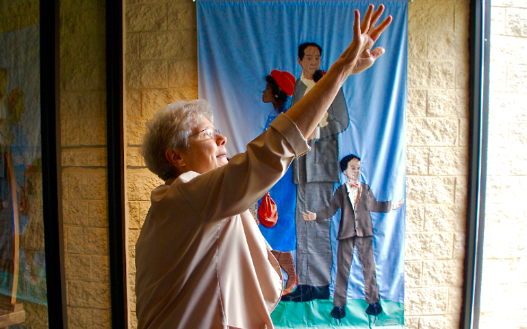 Springfield Dominican Sr. Joanne Delehanty explains the features of the entrance to St. Benedict the African Catholic Church in Chicago's Englewood neighborhood. (GSR photo / Dan Stockman)