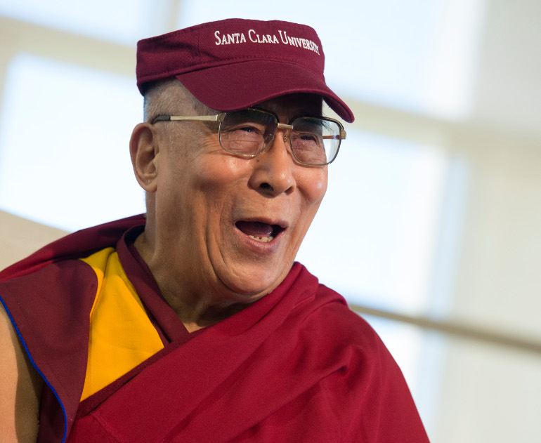 The Dalai Lama wears a Santa Clara University visor during his visit at the Jesuit university Feb. 24. (Photo by Charles Barry/Santa Clara University)