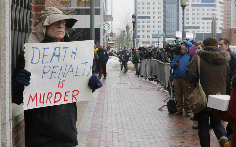 A man protests against the death penalty outside the trial of accused Boston Marathon bomber Dzhokhar Tsarnaev on March 4 in Boston. (CNS/Reuters/Brian Snyder)