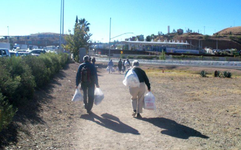 Loretto members carry socks and medical supplies across the border to Casa Nazareth in Nogales, Mexico, on a previous trip. (Mary Ann McGivern)
