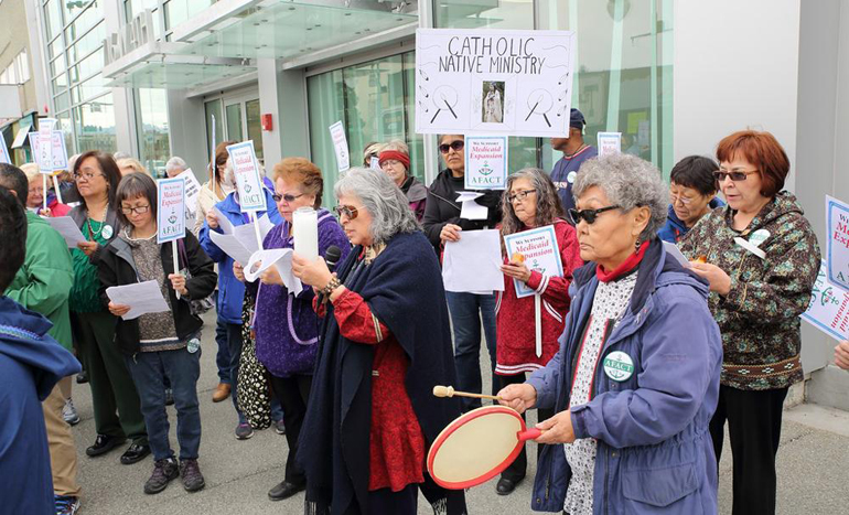 Sr. Mary Peter Diaz (center, in red with dark blue blanket) leads a prayer rally in support of Medicaid expansion in Alaska on May 14. (Ron Nicholl Photography)