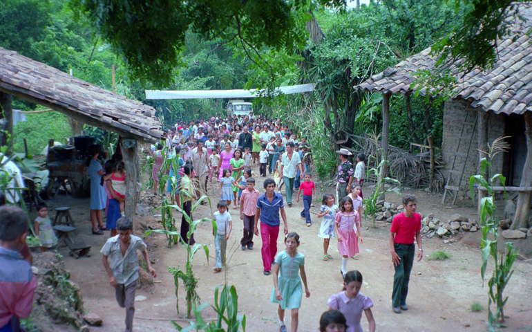 A crowd of people from San Antonio Los Ranchos in Chalatenango, El Salvador, walk with Archbishop Oscar Romero as he arrives to celebrate Mass in 1979. (CNS/Octavio Duran) 