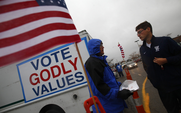 People talk outside an early voting center Oct. 30 in Columbus, Ohio. (CNS/Reuters/Eric Thayer)