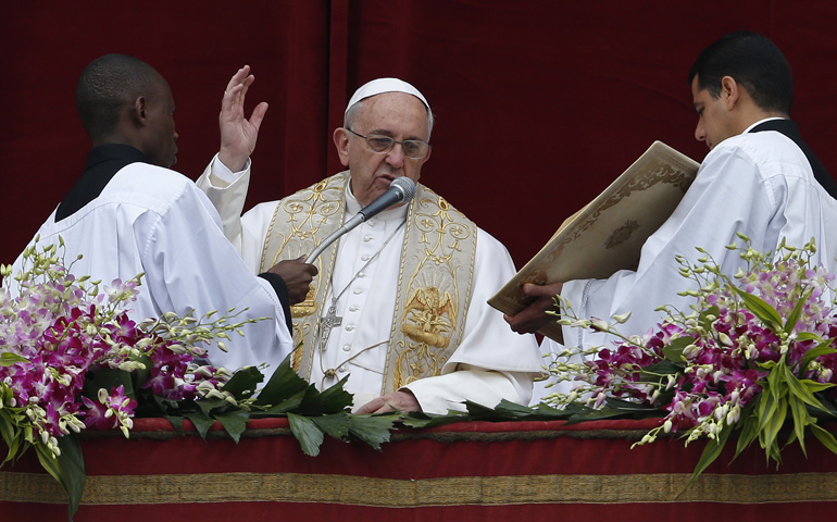 Pope Francis delivers his Easter blessing from the central balcony of St. Peter's Basilica on Sunday at the Vatican. (CNS/Paul Haring)