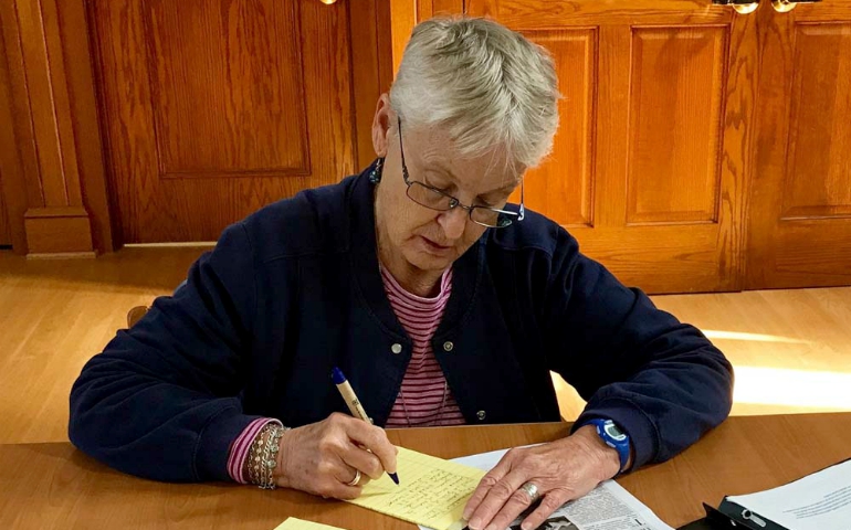 Sr. Edith Hart of the Religious of the Sacred Heart of Mary writes her letter to House Speaker Paul Ryan. (Photo courtesy of the A Fair and Moral Budget: Nuns Write Letters to Paul Ryan Facebook page)