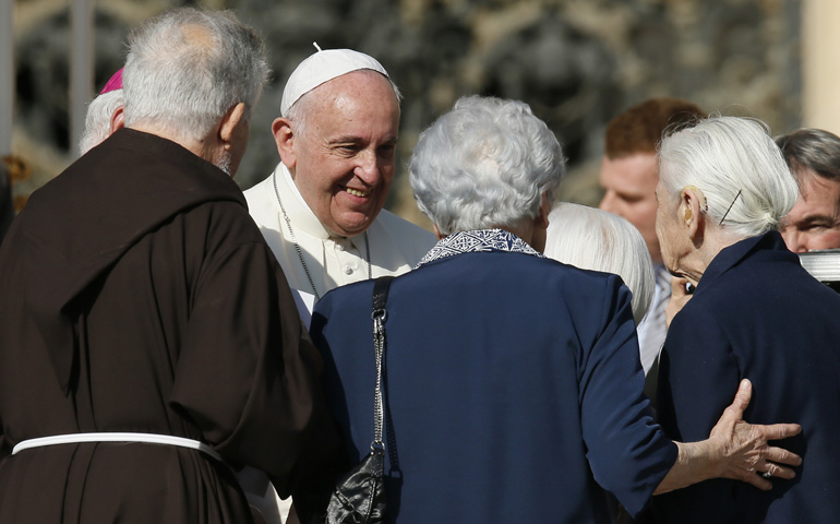 Pope Francis greets people during an encounter with the elderly Sunday in St. Peter's Square at the Vatican. (CNS/Paul Haring)