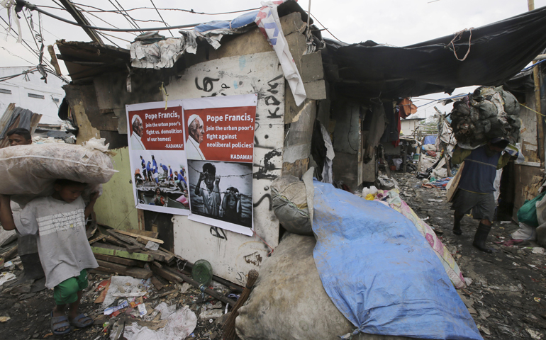 Residents carry plastics for recycling at the garbage dumpsite of Payatas Jan. 13 in Quezon City, Philippines. (AP Photo/Bullit Marquez)