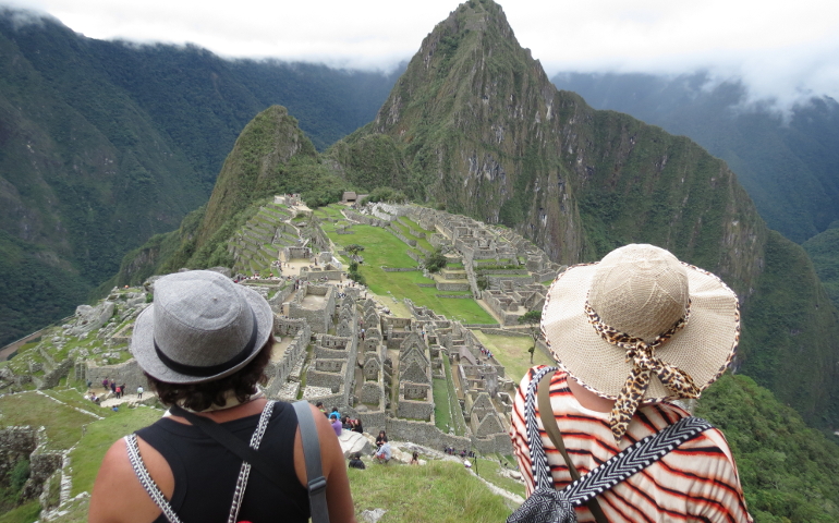 Two women view Machu Picchu, an ancient Incan city in the Andes mountain system, in Peru. (Wikimedia Commons/RicardoMarconato)