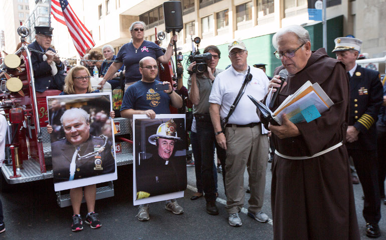 Franciscan Fr. Chris Keenan, chaplain for the New York Fire Department, reads the last homily from Franciscan Fr. Mychal Judge during the Walk of Remembrance in New York City Sept. 11 this year. (CNS/Octavio Duran)