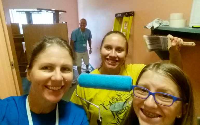  From left, Notre Dame graduate Susan Walton, 17-year-old daughter Makira and 13-year-old daughter Caroline get ready to paint a resident's room at South Bend's YWCA as Arthur Walton looks on. (Susan Walton)