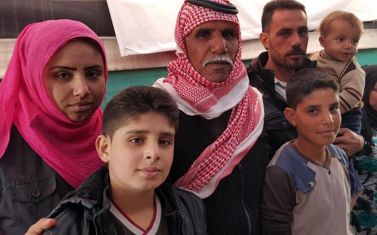 The family of Abdel Karim, third from left, who fled the city of Aleppo, Syria, in 2012 and are living, as many Syrian refugees do, in tents. In their case, they are staying not far from the city of Zahle, Lebanon. (GSR/Chris Herlinger)