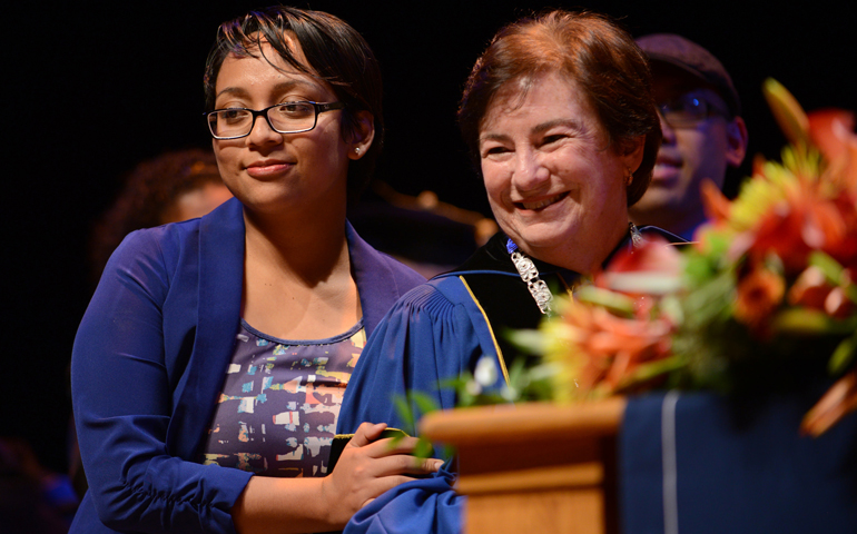 Donna Carroll, president of Dominican University, poses with alumna Fanny Lopez, who was an undocumented student herself, during a convocation honoring Carroll’s advocacy for undocumented students in 2014. (Dominican University)