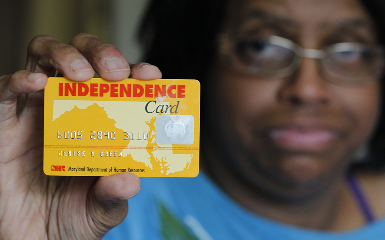 Denise Green displays her "Independence Card," which is issued by the state of Maryland and holds federal SNAP benefits, at her home in Silver Spring, Md. She purchases her food with help of the Supplemental Nutrition Assistance Program, or SNAP. Green worries that she and others will be affected by House members' decision in mid-July to pass a farm bill without funding for nutrition programs. (CNS/Bob Roller)