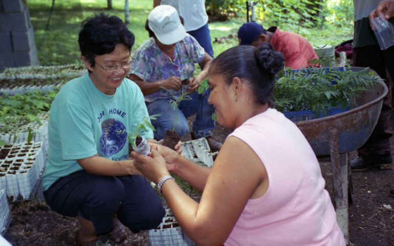 Sr. Jocelyn "Joji" Fenix shares a plant with Maryknoll Pastoral Center member Marcelina, a member of ECODIC, a Christian organization founded by the pastoral center to promote community development and ecologically sustainable sources of income. (Provided by Maryknoll Sisters)