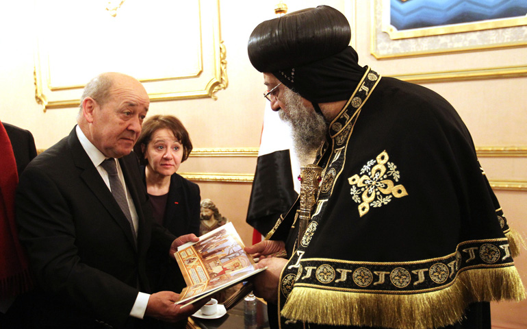 French Defense Minister Jean-Yves Le Drian meets with Pope Tawadros II of Alexandria, patriarch of the Coptic Orthodox Church, at the Coptic cathedral in Cairo in late February. Earlier in the month, the Islamic State group released a video of the killing of Egyptian Christians in Libya. (CNS/EPA/Khaled Elfiqi)