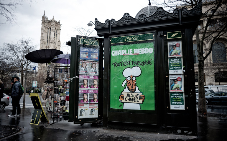 A newsstand in Paris displays a poster of the Jan. 14 issue of "Charlie Hebdo." (Newscom/SIP/Nicolas Messyasz)