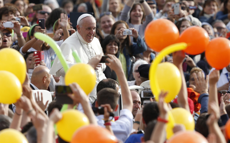 Pope Francis greets the crowd as he arrives to lead his general audience Wednesday in St. Peter's Square at the Vatican. (CNS/Paul Haring)