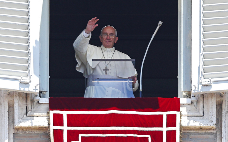 Pope Francis waves as he leads the Angelus Sunday from the window of his studio overlooking St. Peter's Square at the Vatican. (CNS/Reuters/Max Rossi)