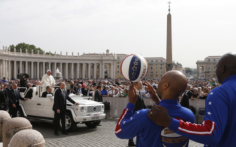 Members of the Harlem Globetrotters watch as Pope Francis arrives to lead his general audience Wednesday in St. Peter's Square at the Vatican. (CNS/Paul Haring)