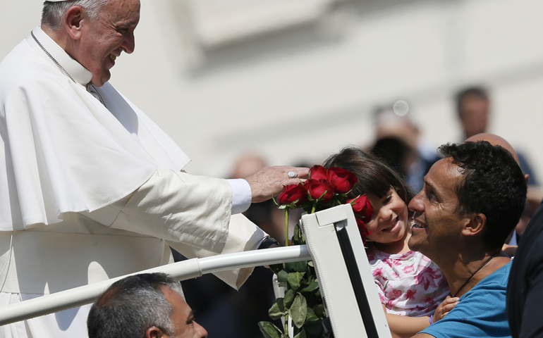 Pope Francis greets family members during his general audience Wednesday in St. Peter's Square at the Vatican. (CNS/Paul Haring)