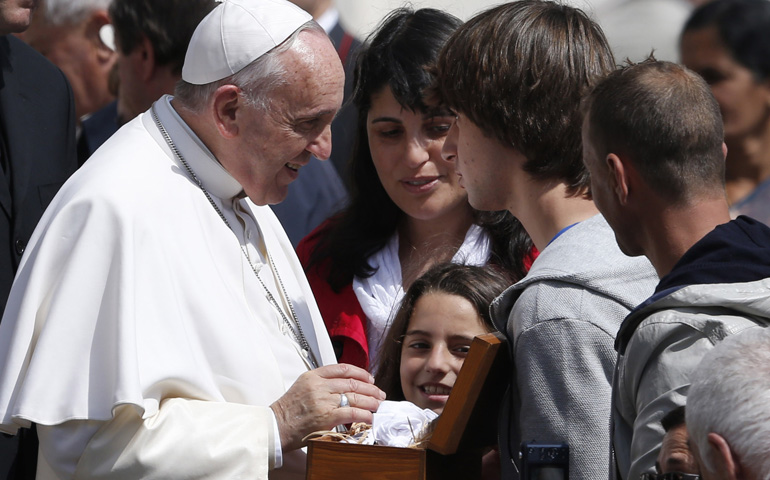 Pope Francis talks to young people during his general audience Wednesday in St. Peter's Square at the Vatican. (CNS/Paul Haring)
