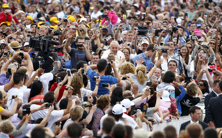 Pope Francis waves as he arrives to lead his weekly general audience Wednesday in St. Peter's Square at the Vatican. (CNS/Reuters/Tony Gentile)