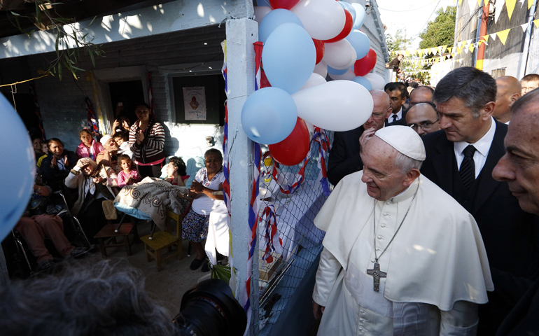 Pope Francis arrives to meet people gathered at a house as he visits Banado Norte, a poor neighborhood in Asuncion, Paraguay, on July 12. (CNS/Paul Haring) 