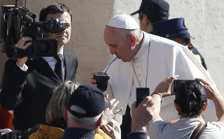 Pope Francis drinks mate, the traditional Argentine herbal tea, as he arrives to lead his general audience Wednesday in St. Peter's Square at the Vatican. (CNS/Paul Haring)