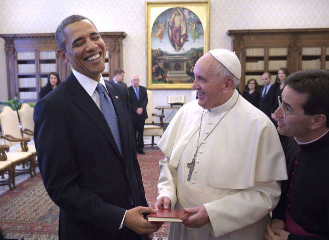 U.S. President Barack Obama shares a laugh with Pope Francis as he receives a copy of the pope's apostolic exhortation, "Evangelii Gaudium" ("The Joy of the Gospel"), during a private audience Thursday at the Vatican. (CNS/Stefano Spaziani, pool)