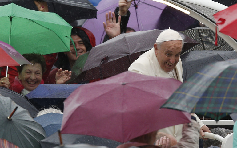 Rain falls as Pope Francis arrives to lead his general audience Wednesday in St. Peter's Square at the Vatican. (CNS/Paul Haring)