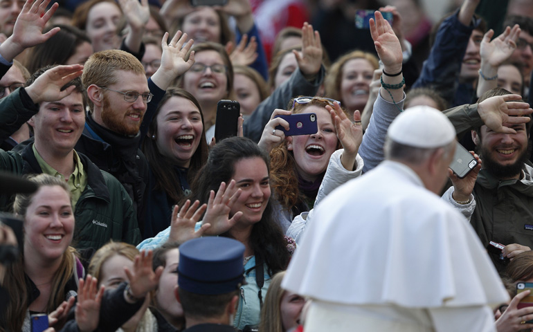 Students from the Austrian program of Franciscan University of Steubenville react as Pope Francis arrives to lead his general audience Wednesday in St. Peter's Square at the Vatican. (CNS/Paul Haring)