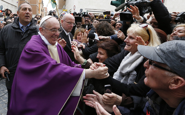 Domenico Giani, head of the Vatican police, in glasses behind Pope Francis, looks on as the newly elected pontiff greets people after celebrating Mass March 17 at St. Anne's Parish within the Vatican. (CNS/Paul Haring) 
