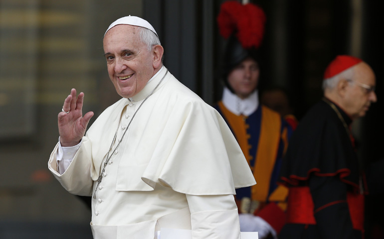 Pope Francis waves at the media as he arrives for the morning session of the extraordinary Synod of Bishops on the family Thursday at the Vatican. (CNS/Paul Haring)