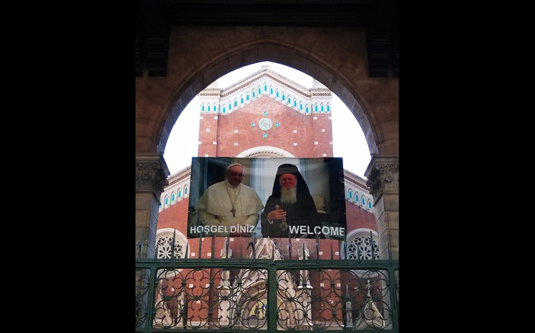 A poster displayed outside of a Catholic church in Istanbul welcomes Pope Francis, who will meet with Ecumenical Patriarch Bartholomew of Constantinople, right, on his trip to Turkey. (CNS/Nathalie Ritzmann)
