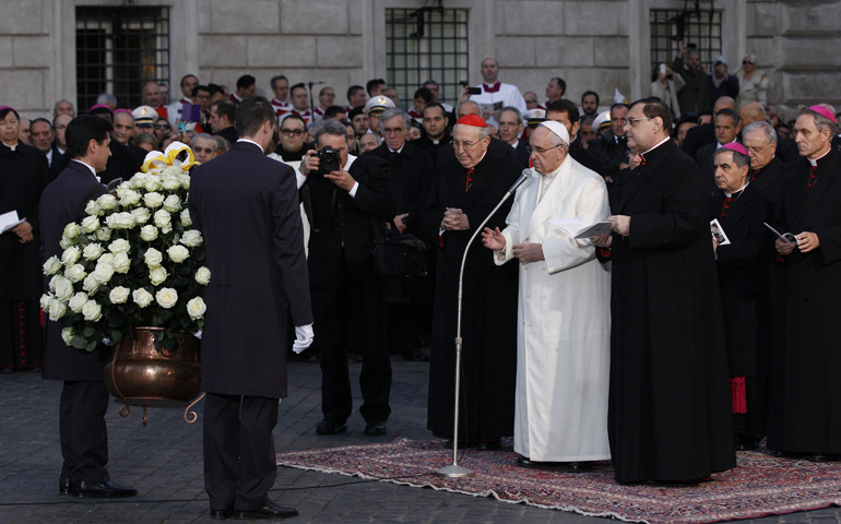 Pope Francis blesses a wreath while praying Monday, the feast of the Immaculate Conception, at a statue of Mary overlooking the Spanish Steps in Rome. (CNS/Paul Haring) 