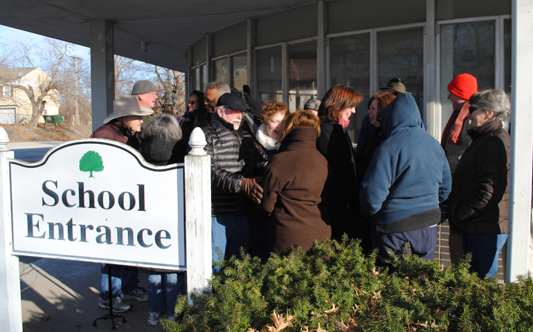St. Francis Xavier parishioners gather in front of the parish school Feb. 12 in Kansas City, Mo. (NCR photo/Soli Salgado) 