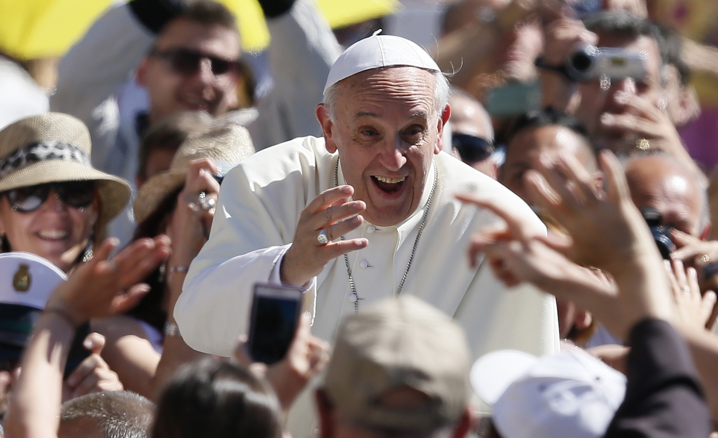 Pope Francis greets pilgrims as he arrives for his weekly general audience in St. Peter's Square at the Vatican June 12. (CNS photo/Paul Haring)