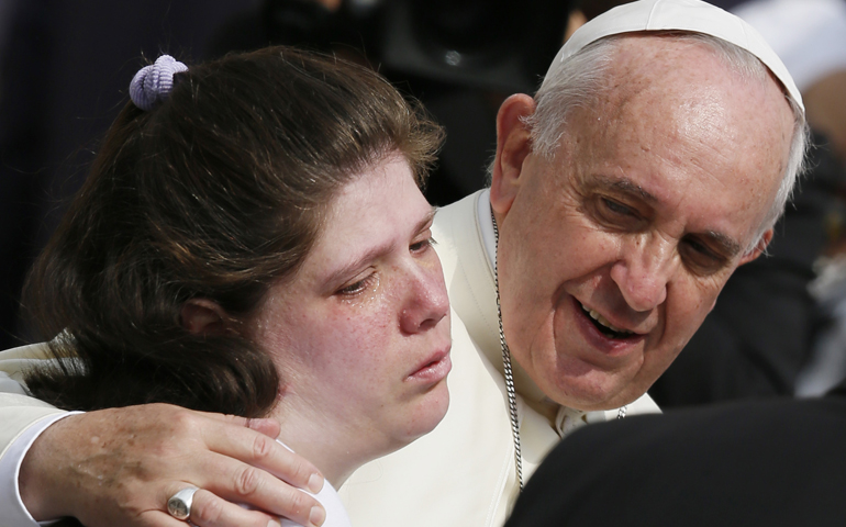 Pope Francis embraces a woman as he greets people with disabilities during his general audience Wednesday in St. Peter's Square at the Vatican. (CNS/Paul Haring) 