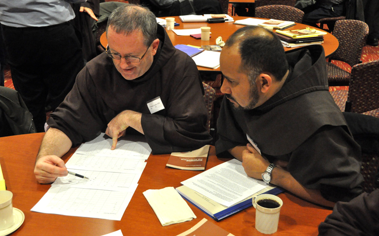 From left, Franciscan Frs. Tom Conway of the New York City-based Holy Name Province and Jose Martinez of the St. Louis-based Sacred Heart Province talk during the December 2012 meeting in Milwaukee of the seven U.S. provinces of the Order of Friars Minor.