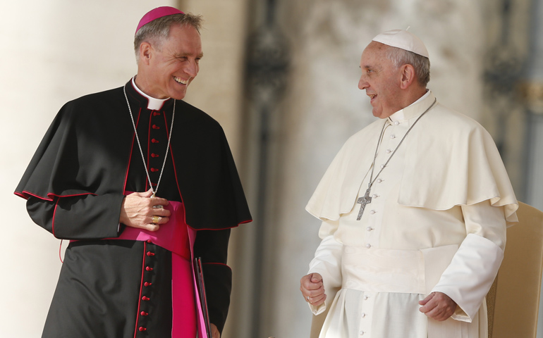 Pope Francis talks with Archbishop Georg Ganswein, prefect of the papal household, as he begins his general audience Oct. 16 in St. Peter's Square at the Vatican. (CNS/Paul Haring)