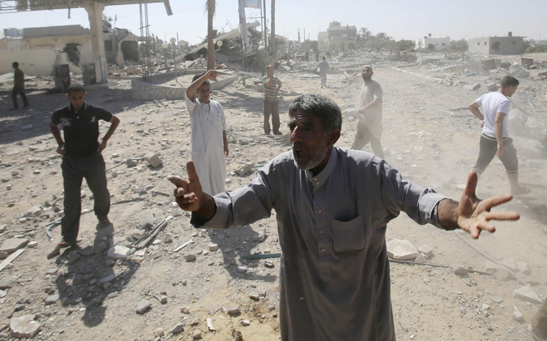 A Palestinian man reacts upon seeing destruction Friday in Khan Younis, Gaza Strip. (CNS/Reuters/Ibraheem Abu Mustafa)