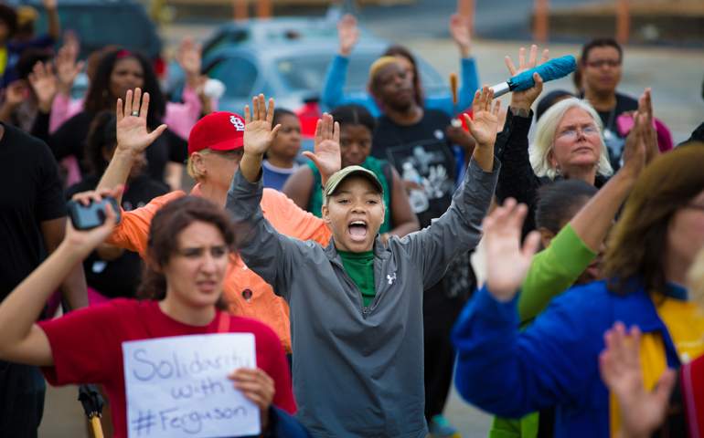 Protesters hold their hands in the air during an Aug. 16 demonstration against the shooting death of Michael Brown in Ferguson, Mo. (CNS/St. Louis Review/Lisa Johnston)