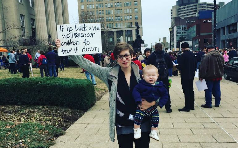 Gillian Mocek holds her son, Simon, and a sign that shares her family's plan for his future, at the Women's March in Louisville, Kentucky, Jan. 21, 2017. (Christian Mocek)