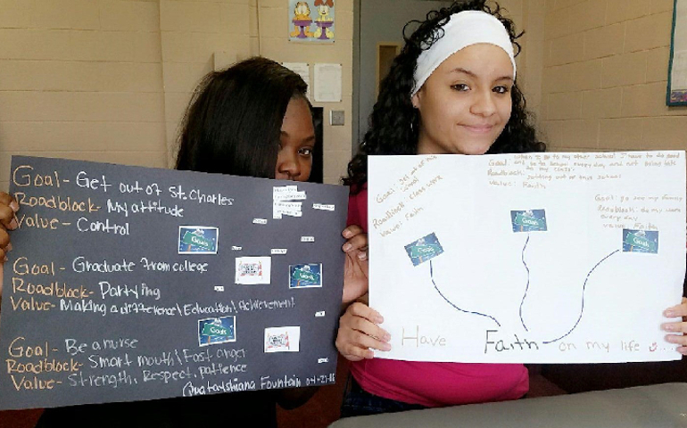 Quatayshiana, left, and Lizandra, two students in the Peace Works program, display their personal goals. (Marquette University/Center for Peacemaking)