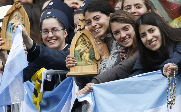 World Youth Day pilgrims hold rosaries and icons as they wait for Pope Francis to arrive to the Municipal Theater on July 27 in Rio de Janeiro. (CNS/Paul Haring) 