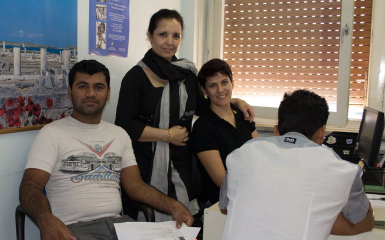Panayiota Agolli (second from right), researcher and field coordinator at the Greek Council for Refugees, interviews a refugee in 2015 in her Athens office. Agolli is collecting data on migrants in Greece for the EVI-MED project, a research initiative lead by Middlesex University in London. (Courtesy Greek Refugee Council)