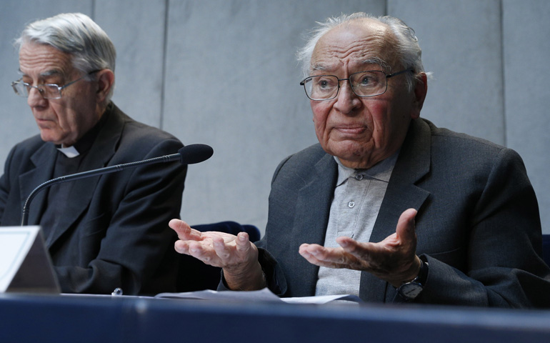 Dominican Fr. Gustavo Gutierrez speaks at a press conference Tuesday to introduce the work of the general assembly of Caritas Internationalis at the Vatican. At left is Jesuit Fr. Federico Lombardi, the Vatican spokesman. (CNS/Paul Haring)