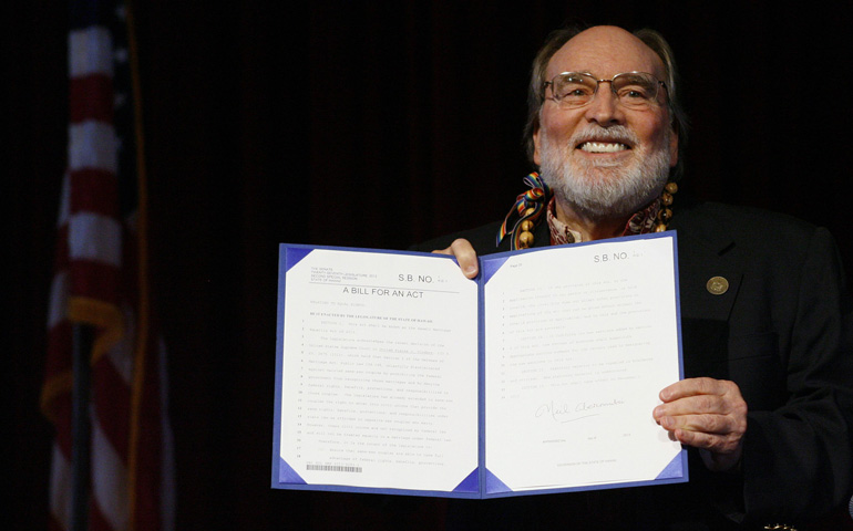 Hawaii Gov. Neil Abercrombie holds up the bill legalizing same-sex marriage in his state after signing it into law Wednesday in Honolulu. (CNS/Reuters/Hugh Gentry)